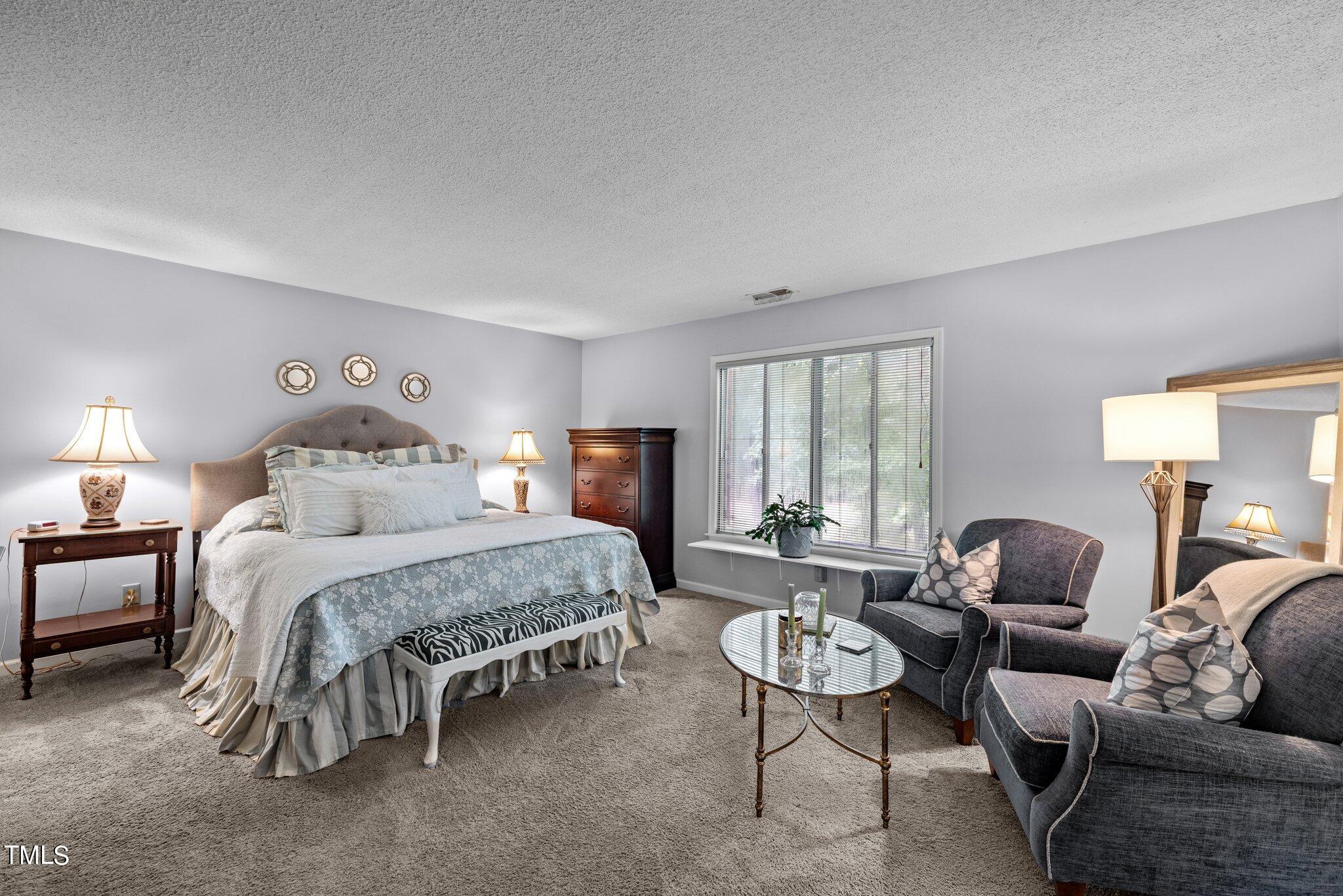1917 Front Street, Unit 4C Durham, NC 27705 - Photo 25 of 53 a bedroom with a bed couches chair and a large window