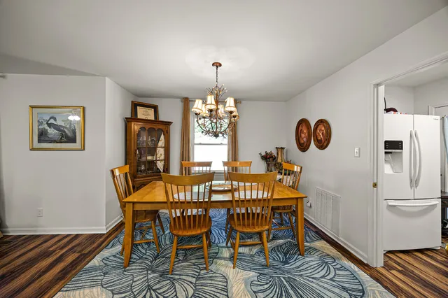 a view of a dining room with furniture and window