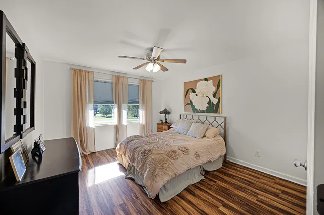 a bedroom with a bed chandelier and a window