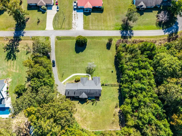 an aerial view of a house with swimming pool