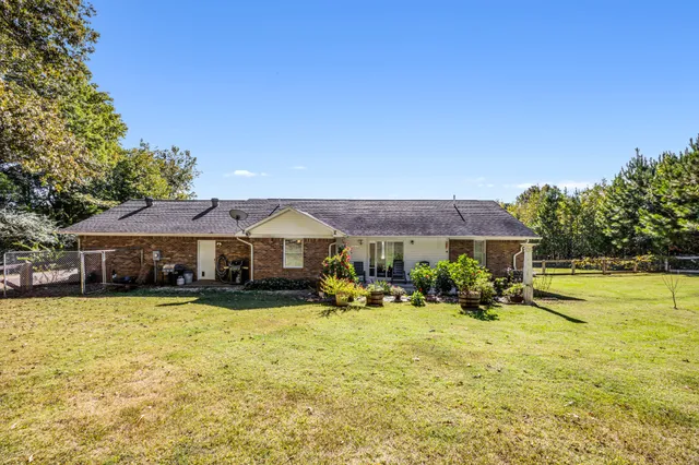 a view of a house with swimming pool and yard