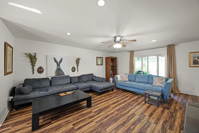 a living room with furniture and wooden floor