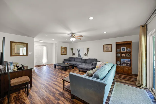 a living room with furniture and wooden floor