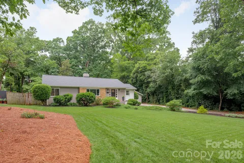 a house with green field in front of it