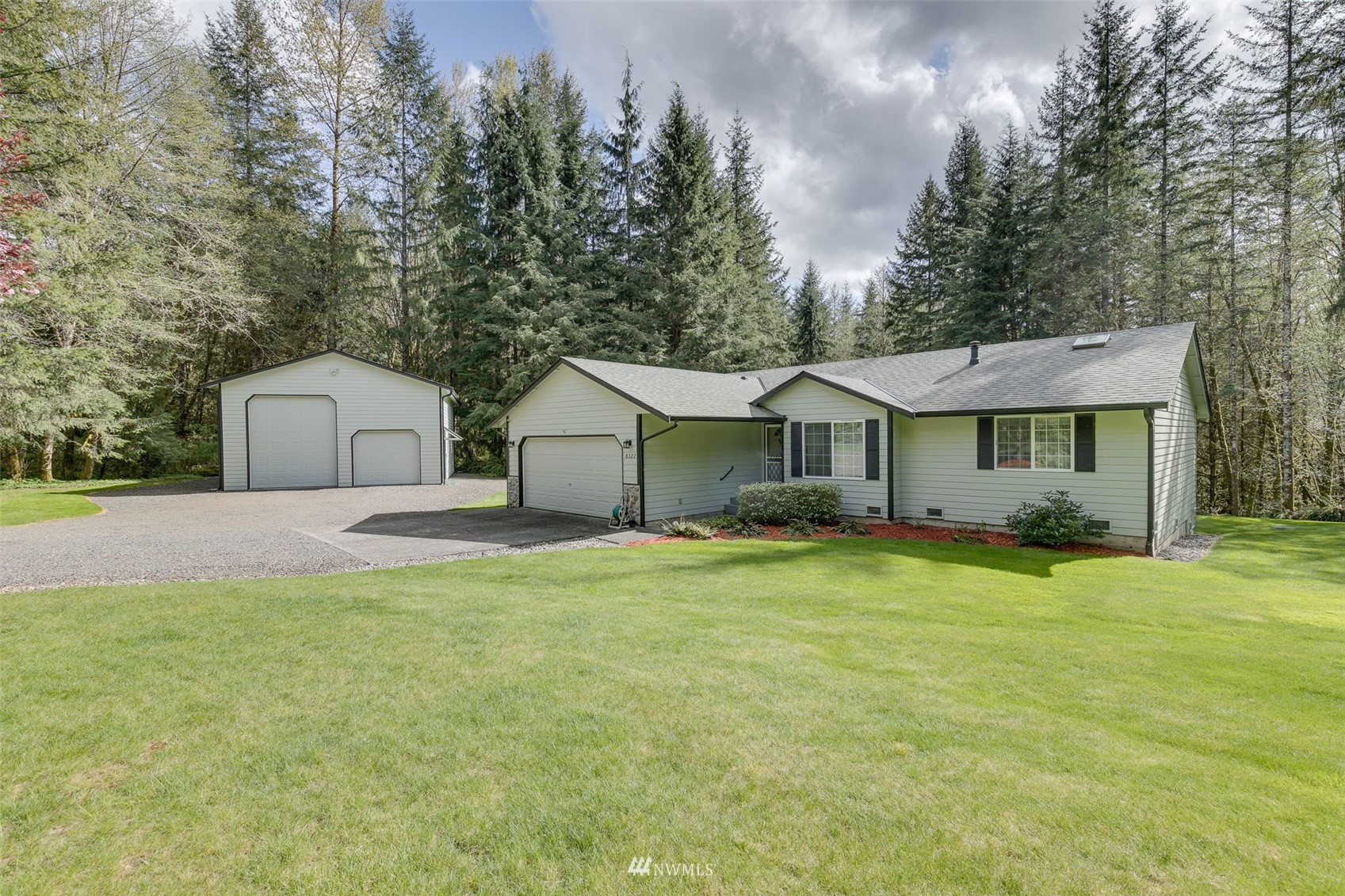 8322 Skinner Road Granite Falls, WA 98252 - Photo 1 of 40 a front view of a house with a yard and trees