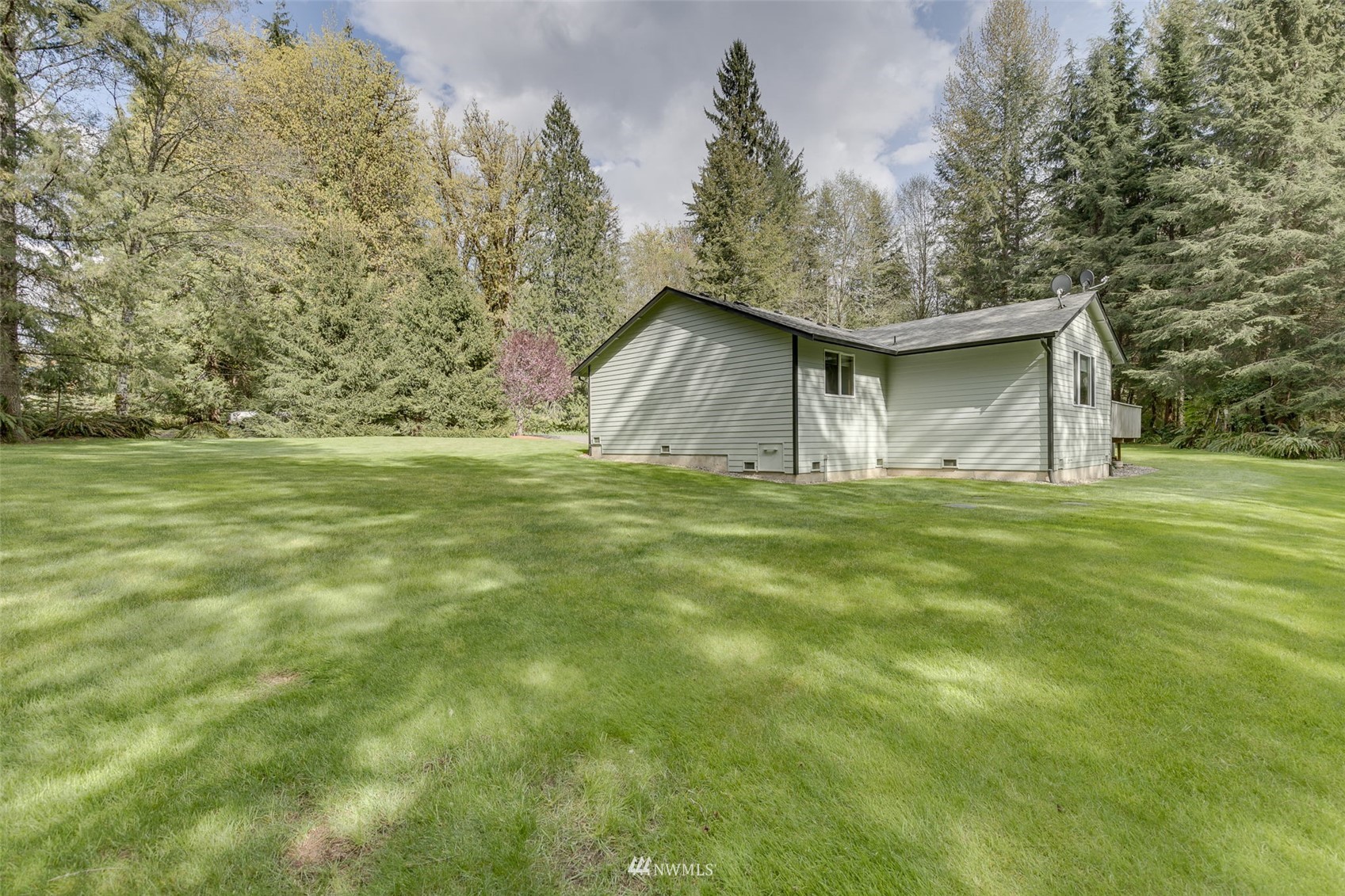 8322 Skinner Road Granite Falls, WA 98252 - Photo 29 of 40 a house with huge green field in front of it
