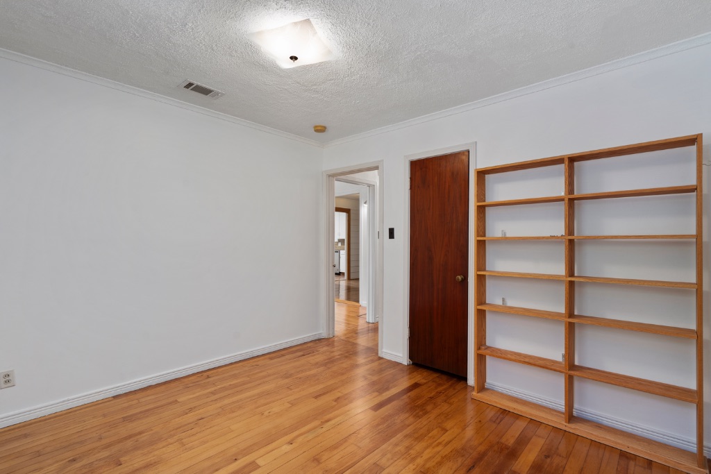 1212 Bentwood Road Austin, TX 78722 - Photo 16 of 32 a view of an empty room with wooden floor and closet
