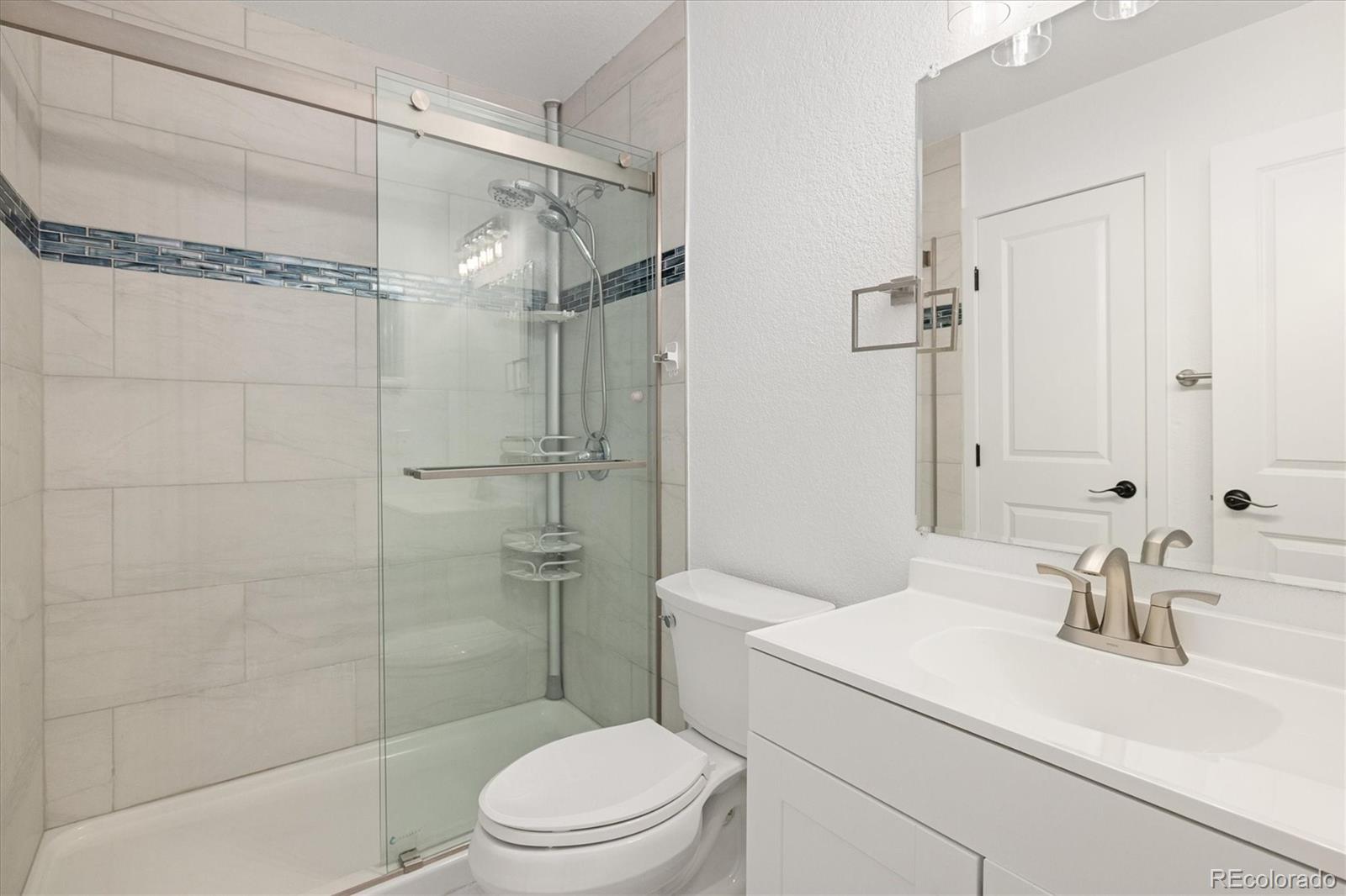 8612 Carr Loop Arvada, CO 80005 - Photo 14 of 35 a bathroom with a sink toilet and shower