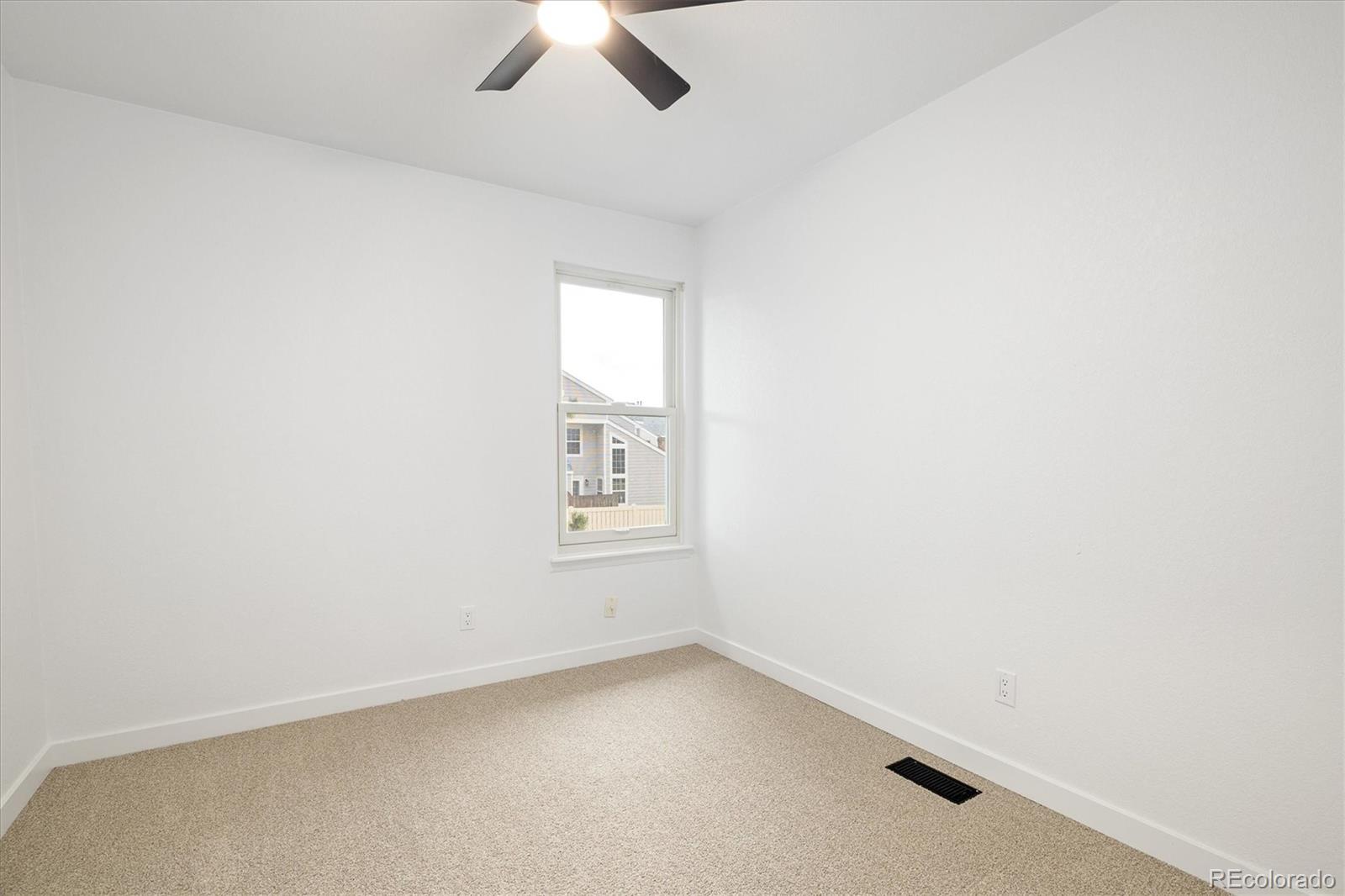 8612 Carr Loop Arvada, CO 80005 - Photo 16 of 35 an empty room with a window and ceiling fan