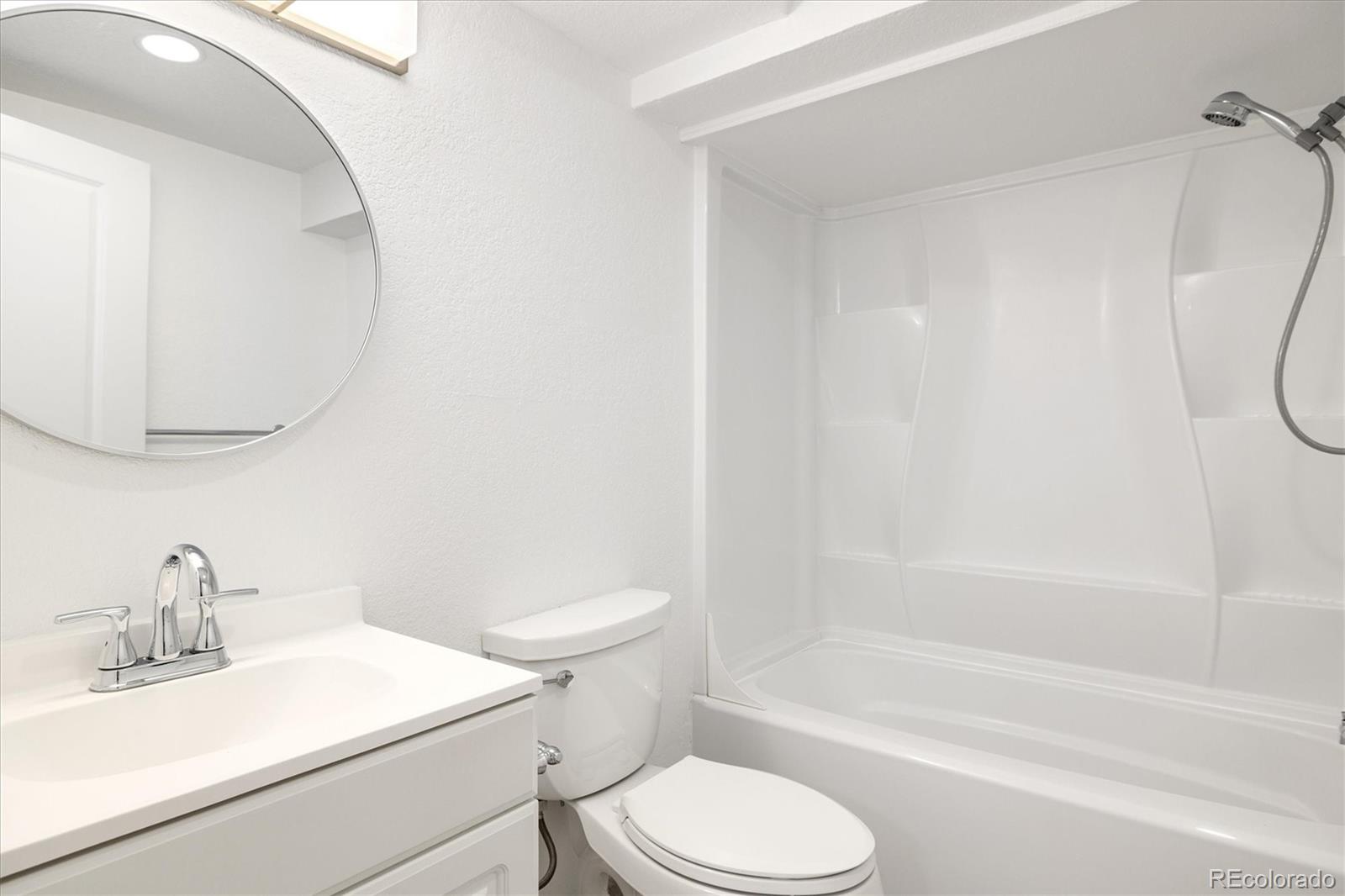 8612 Carr Loop Arvada, CO 80005 - Photo 20 of 35 a white toilet sitting next to a bath tub