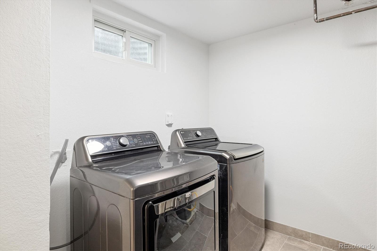 8612 Carr Loop Arvada, CO 80005 - Photo 21 of 35 a utility room with dryer and washer