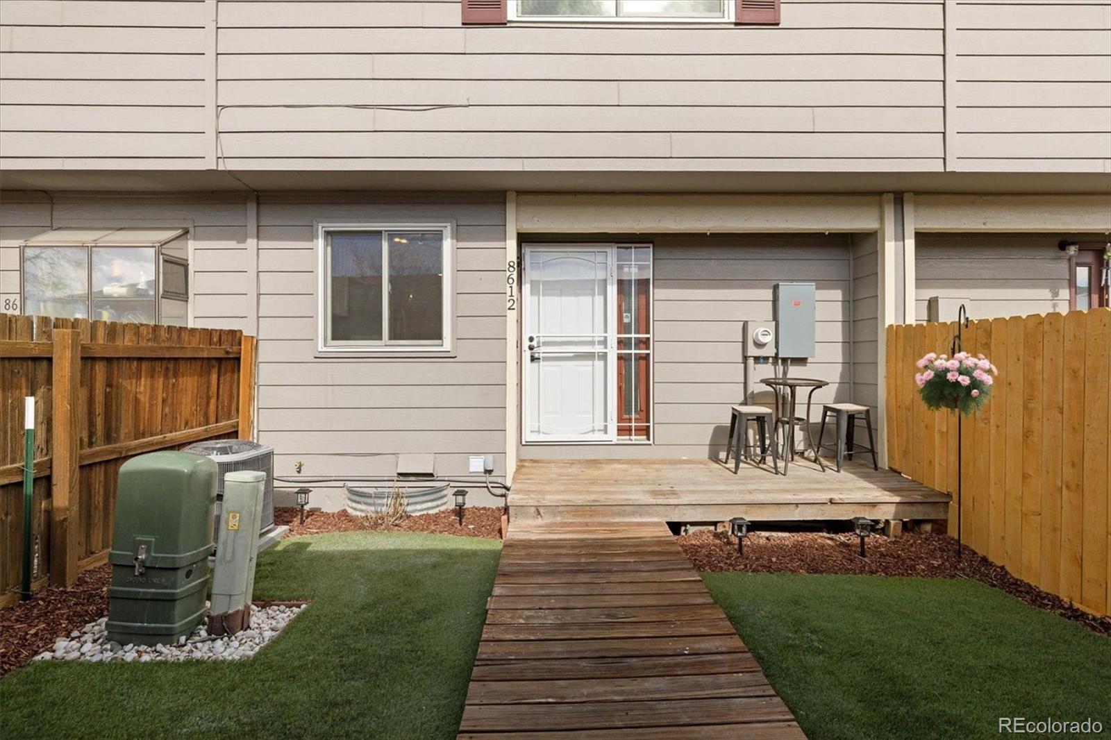 8612 Carr Loop Arvada, CO 80005 - Photo 25 of 35 a view of a backyard with sitting area