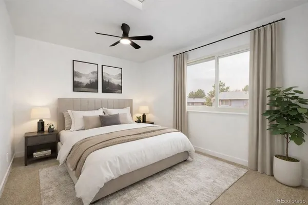 a bedroom with a bed and a potted plant