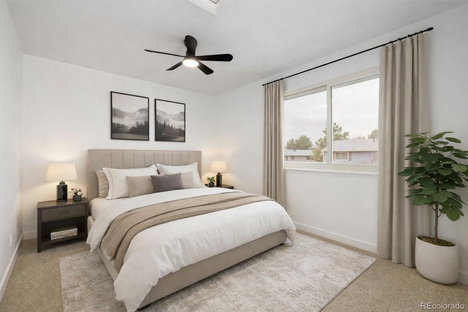 8612 Carr Loop Arvada, CO 80005 - Photo 3 of 35 a bedroom with a bed and a potted plant