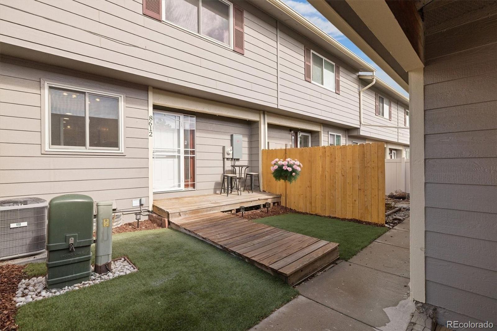 8612 Carr Loop Arvada, CO 80005 - Photo 5 of 35 a front view of a house with a yard