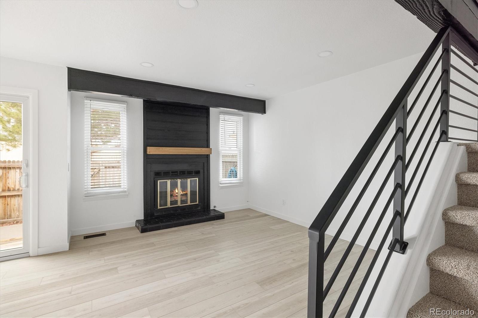 8612 Carr Loop Arvada, CO 80005 - Photo 6 of 35 a view of an empty room with wooden floor and a window