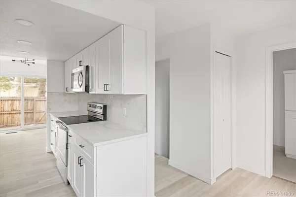a kitchen with stainless steel appliances granite countertop a stove and a refrigerator