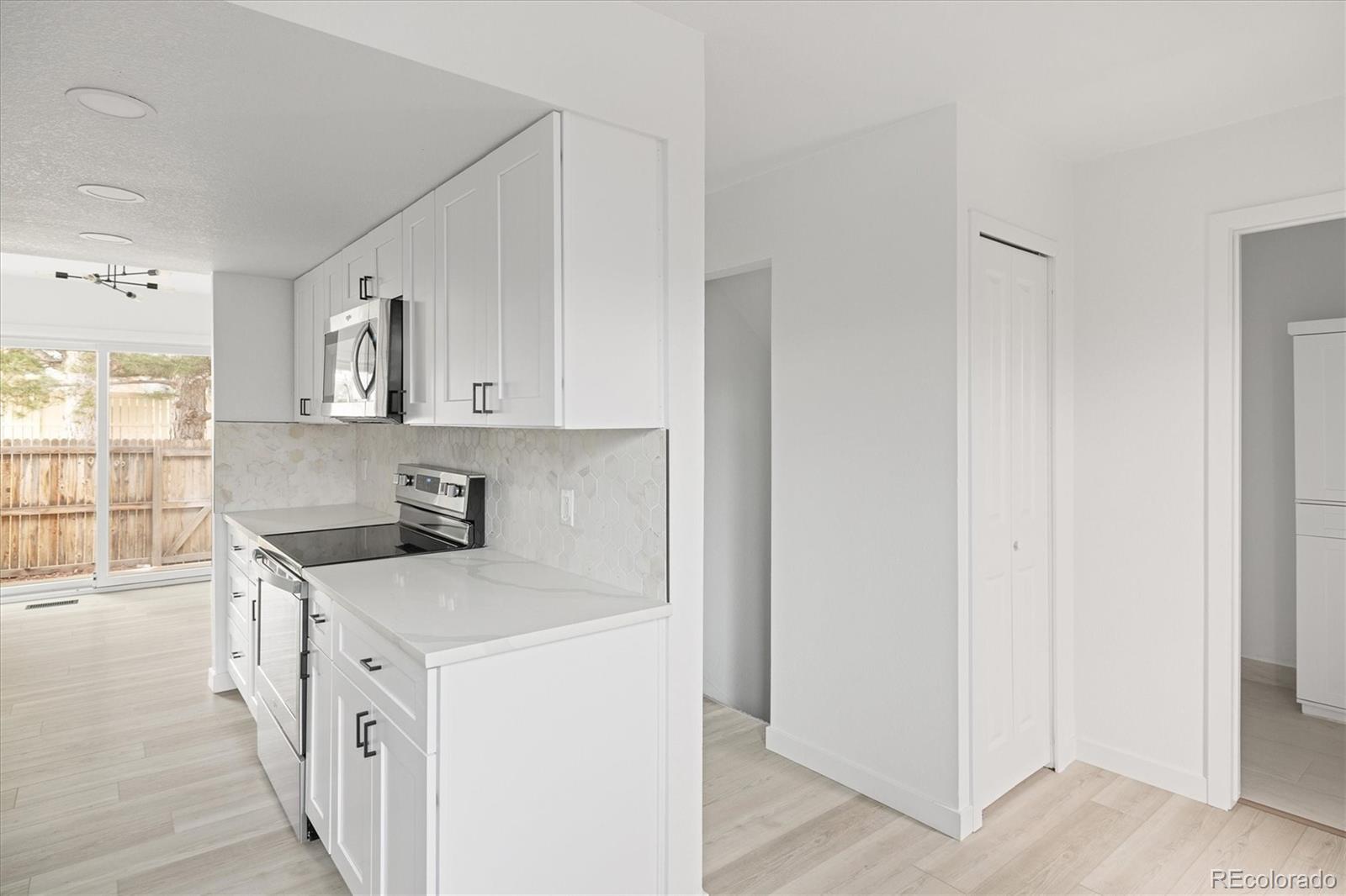 8612 Carr Loop Arvada, CO 80005 - Photo 8 of 35 a kitchen with stainless steel appliances granite countertop a stove and a refrigerator