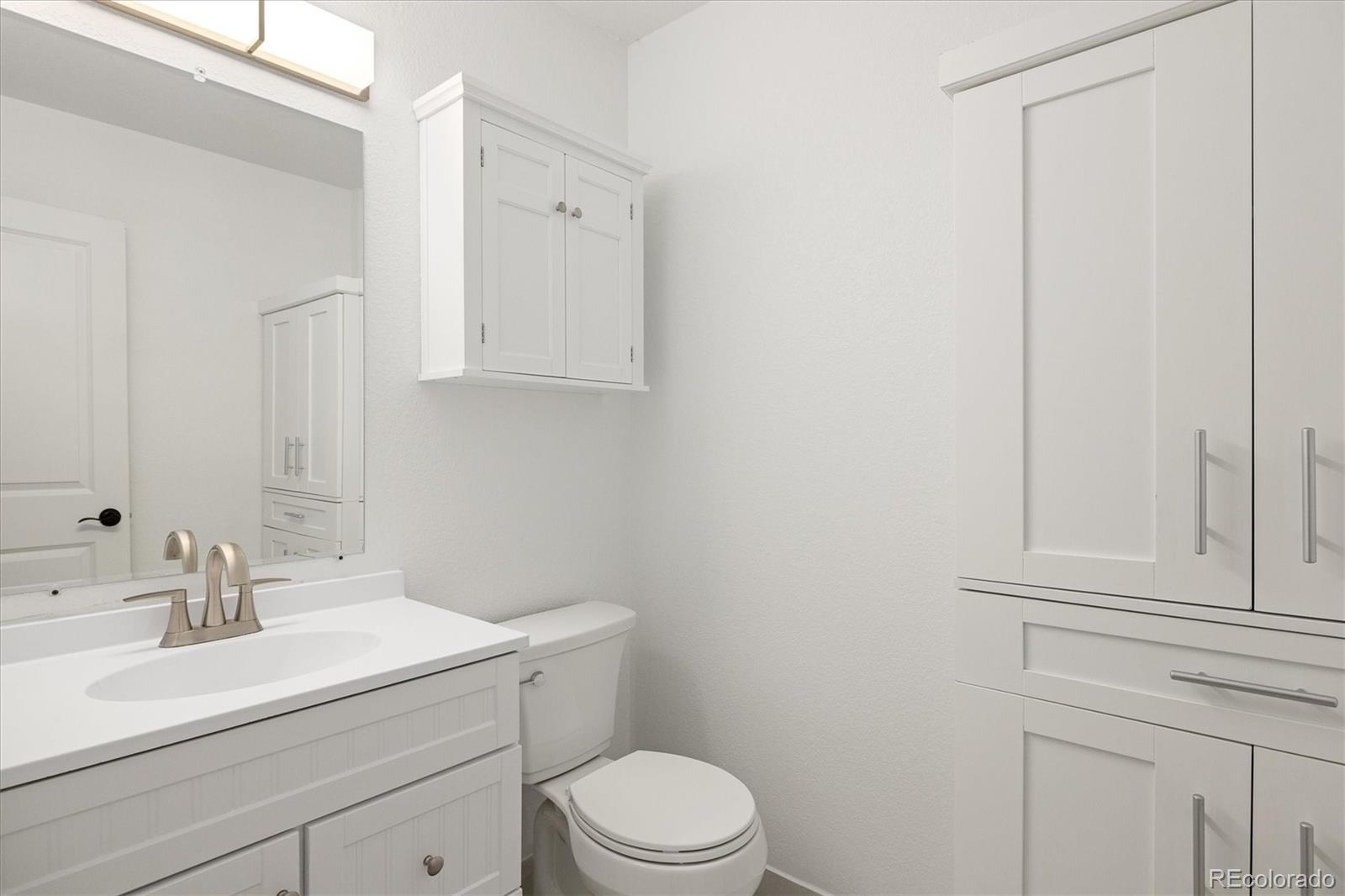 8612 Carr Loop Arvada, CO 80005 - Photo 10 of 35 a bathroom with a sink a toilet and vanity