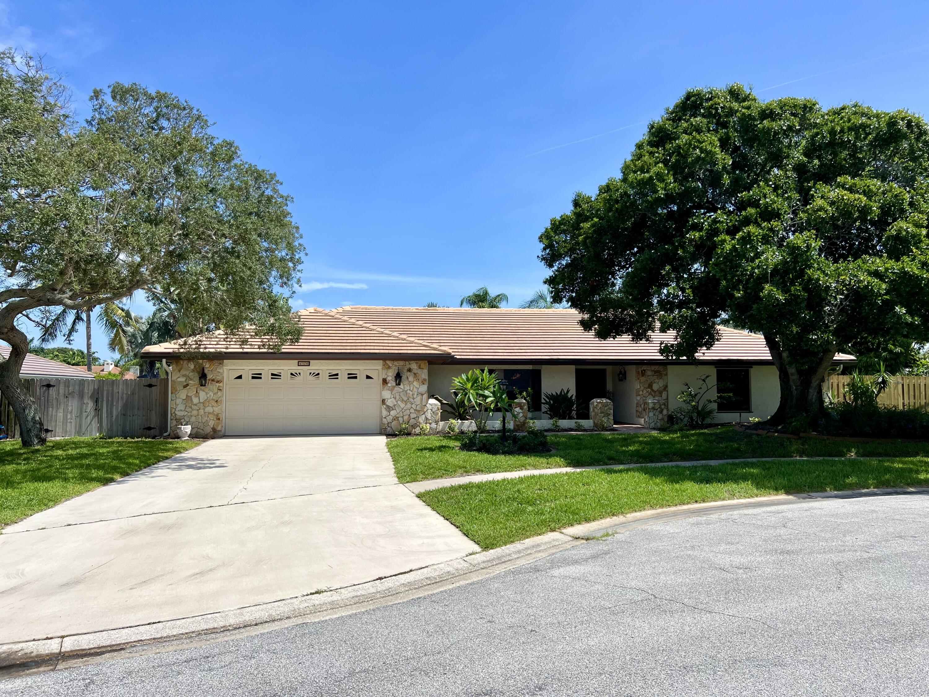 a front view of a house with yard and green space