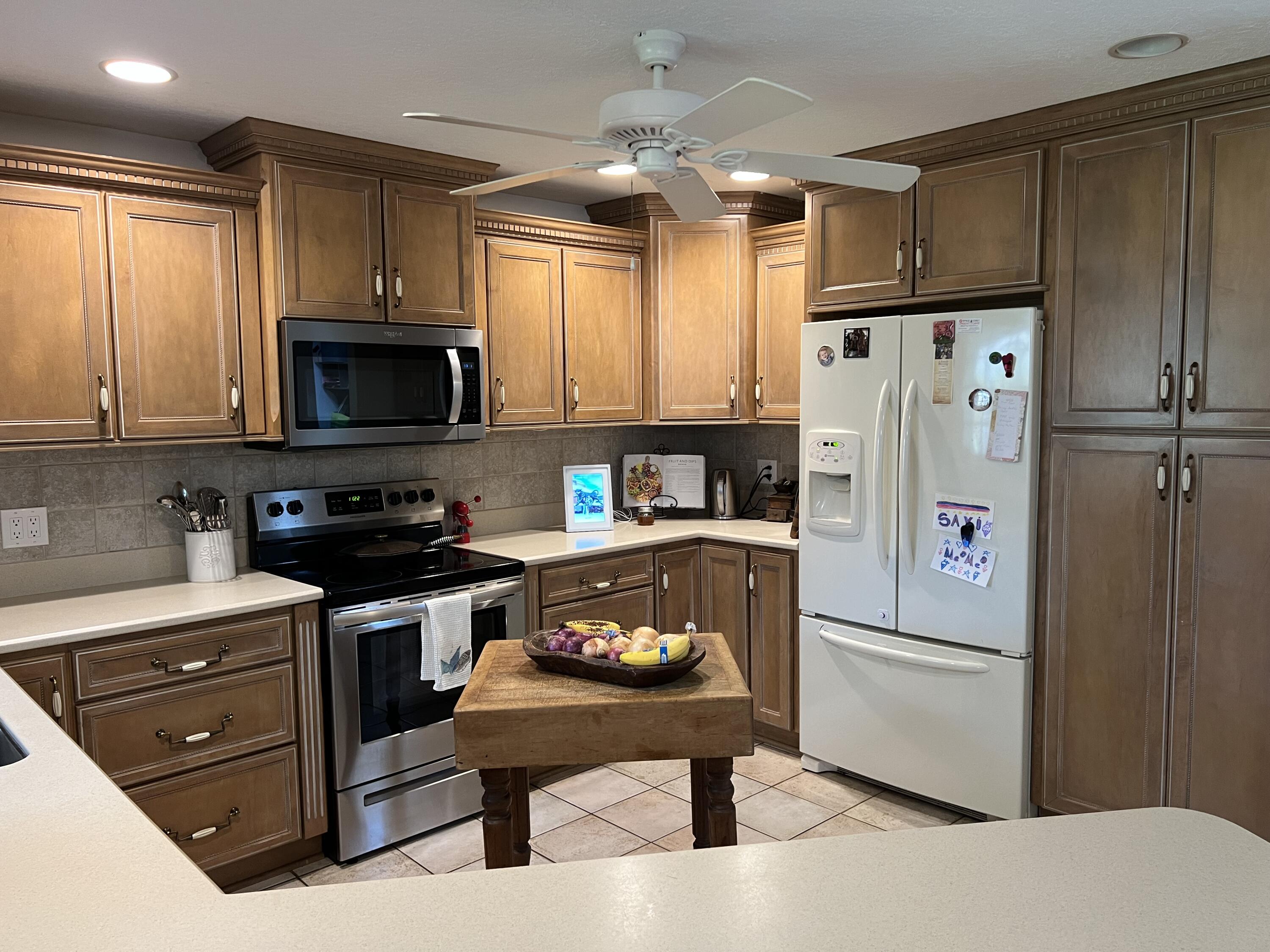 410 Rio Casa Drive South Indialantic, FL 32903 - Photo 14 of 25 a kitchen with a refrigerator a stove a microwave a sink and cabinets