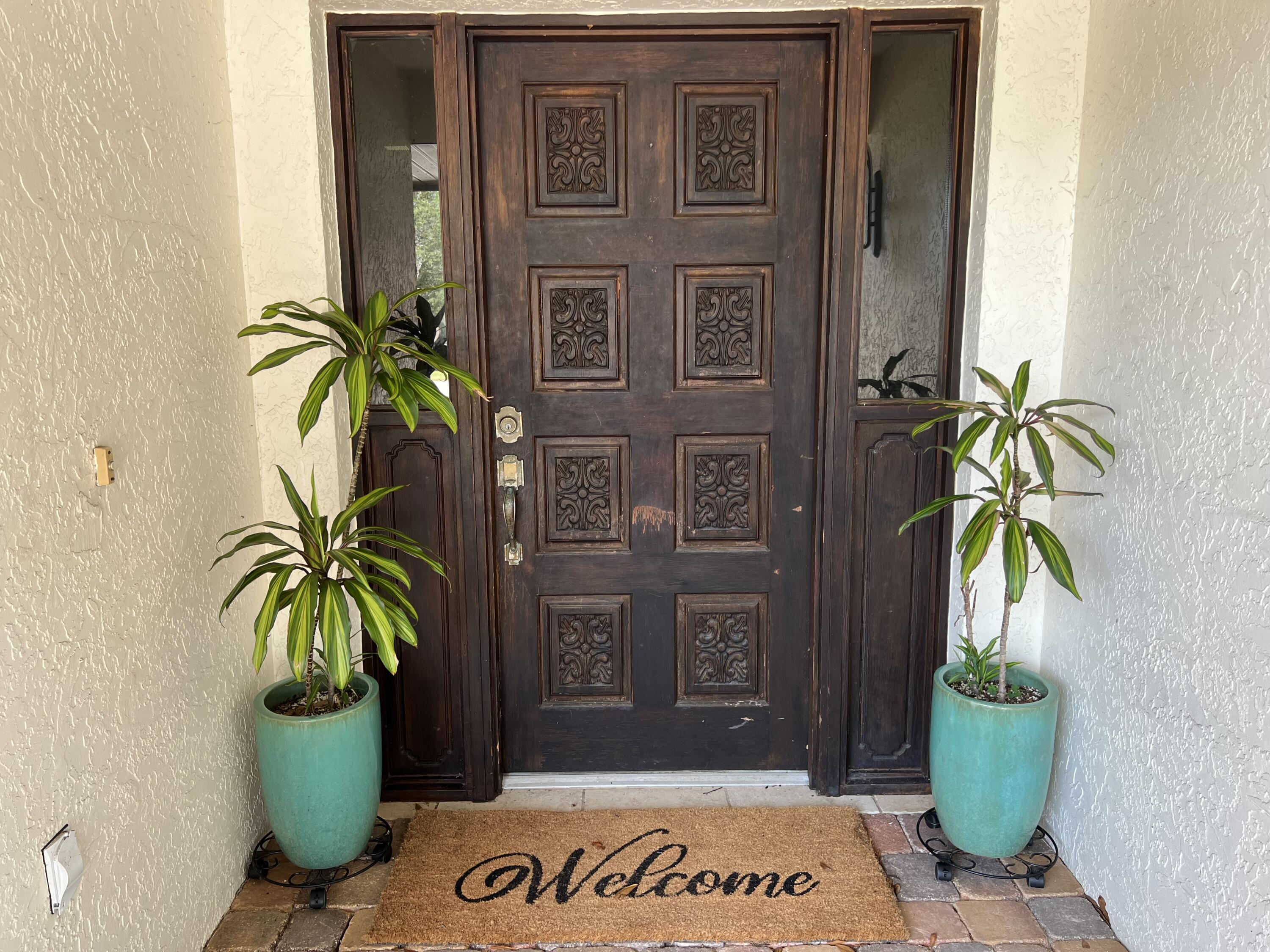 410 Rio Casa Drive South Indialantic, FL 32903 - Photo 2 of 25 a view of a potted plants in front of a door