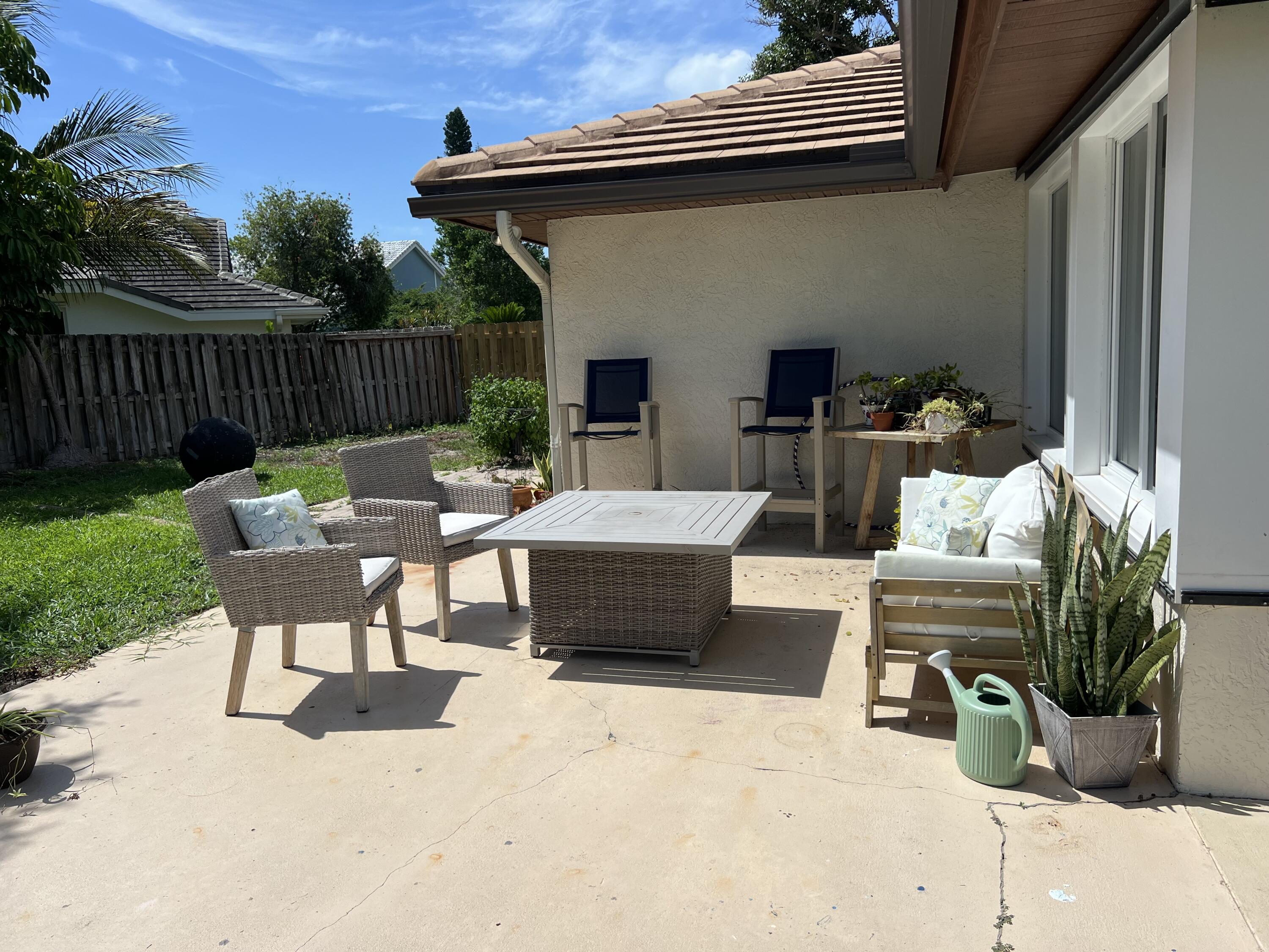 410 Rio Casa Drive South Indialantic, FL 32903 - Photo 22 of 25 a view of a patio with couches chairs potted plants and floor to ceiling window