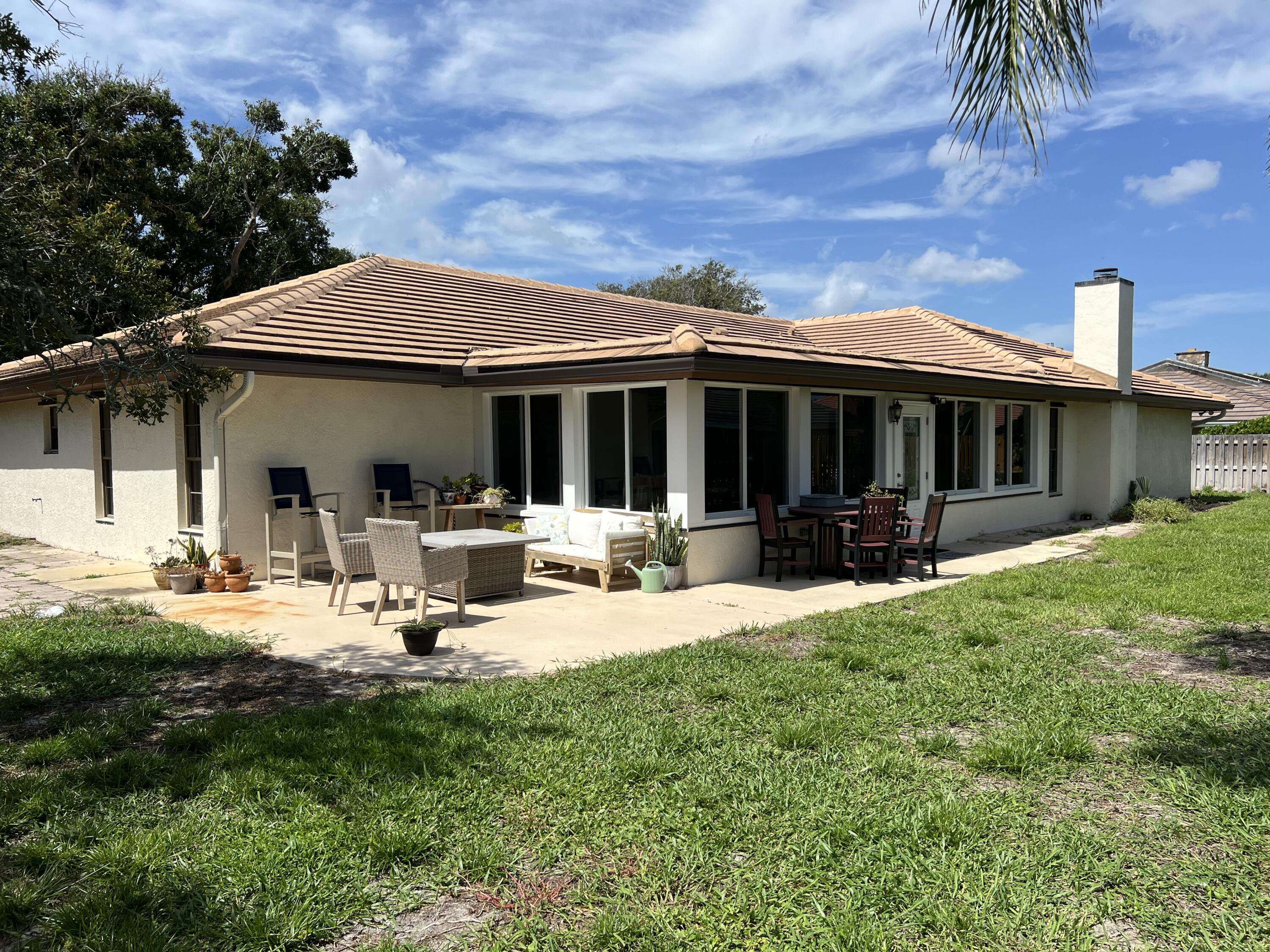 410 Rio Casa Drive South Indialantic, FL 32903 - Photo 23 of 25 a view of a house with backyard sitting area and garden