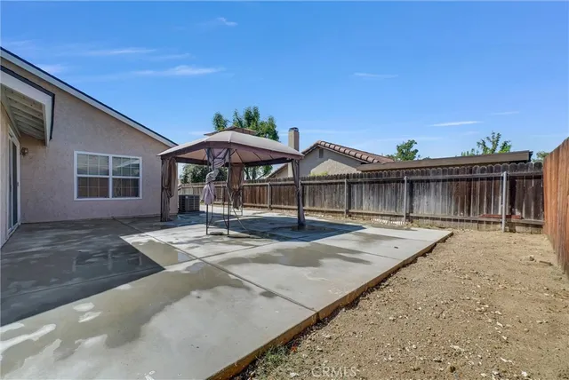 a view of a house with wooden floor and roof with a small yard