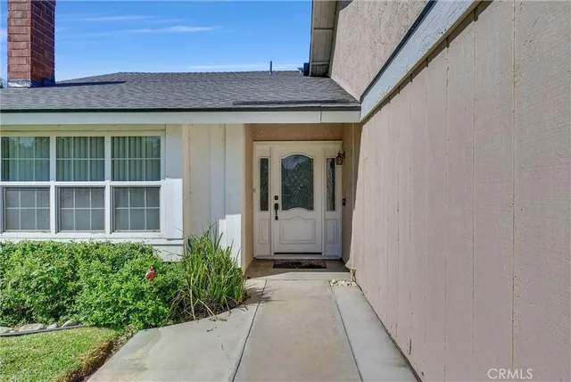 a view of a brick house with potted plants