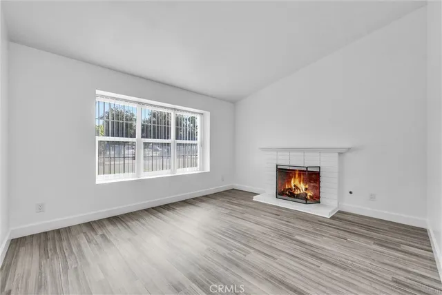 an empty room with a window and a fireplace