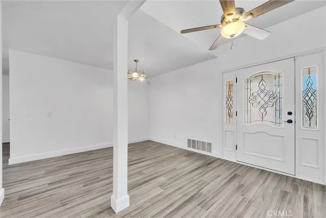 wooden floor in an empty room with a window