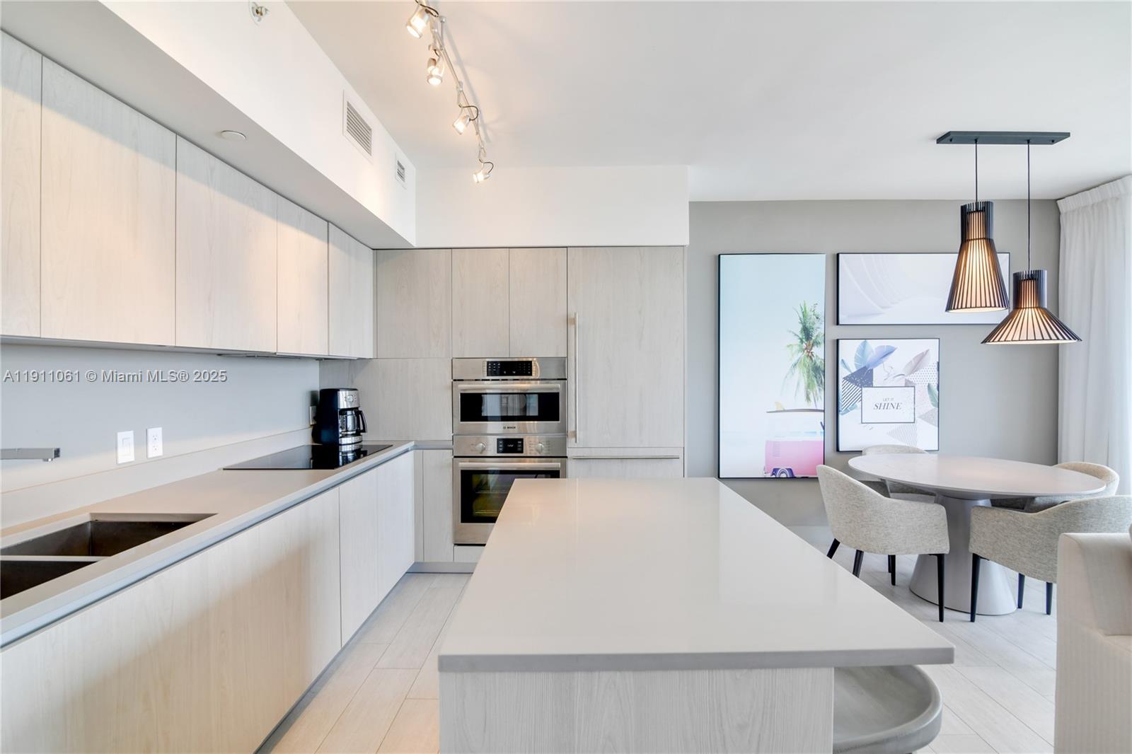 4010 South Ocean Drive, Unit R3206 Hollywood, FL 33019 - Photo 5 of 37 a kitchen with stainless steel appliances a stove a sink a microwave a refrigerator and cabinets