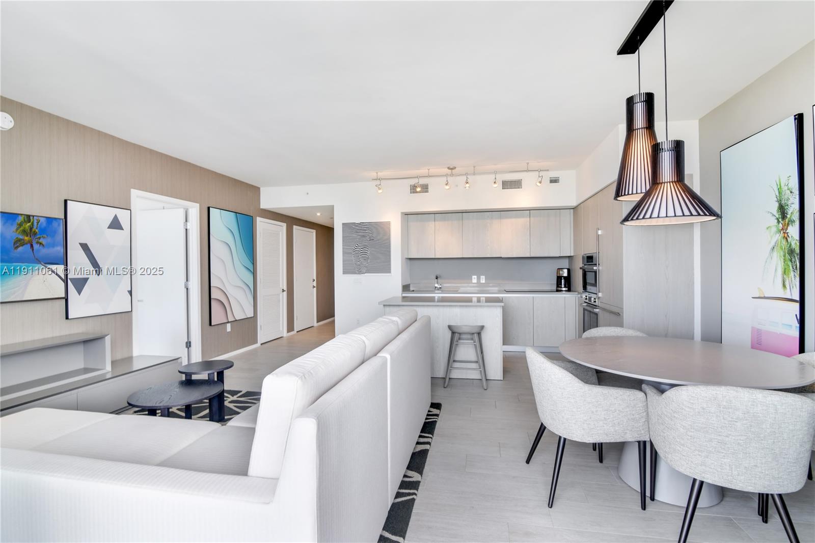 4010 South Ocean Drive, Unit R3206 Hollywood, FL 33019 - Photo 7 of 37 a large kitchen with a table chairs refrigerator and cabinets