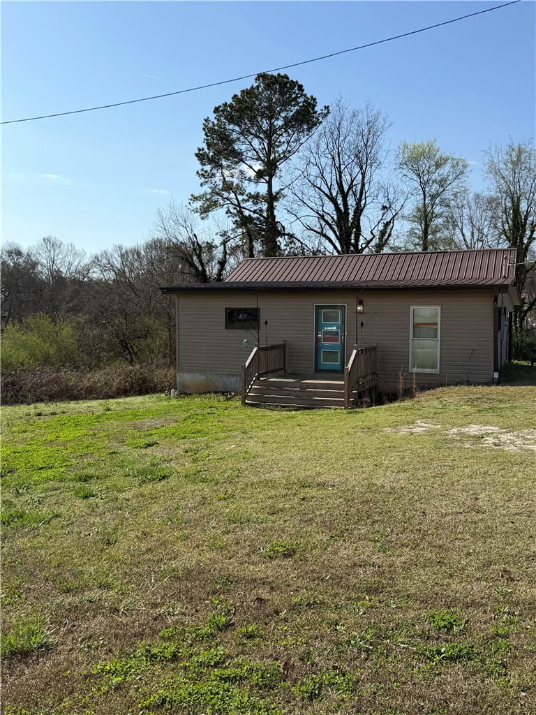 This charming home offers a simple facade with an inviting front entrance.