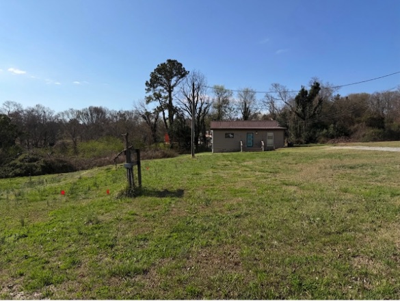 707 South Spring Street Walhalla, SC 29691 - Photo 2 of 20 A spacious lot offers abundant potential with a structure set against a natural backdrop.