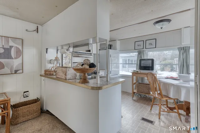 a kitchen with sink cabinets and dining table