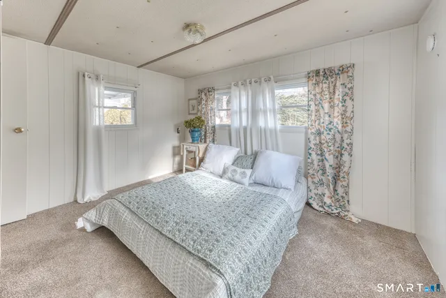 a large bedroom with a bed and large window