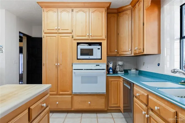 a kitchen with stainless steel appliances granite countertop a sink and cabinets