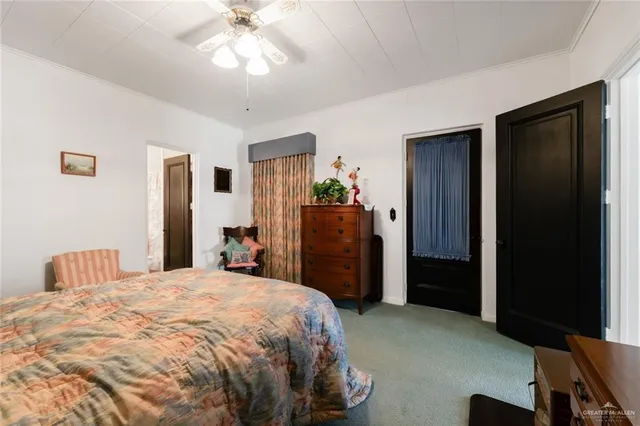 a spacious bedroom with a bed and large window
