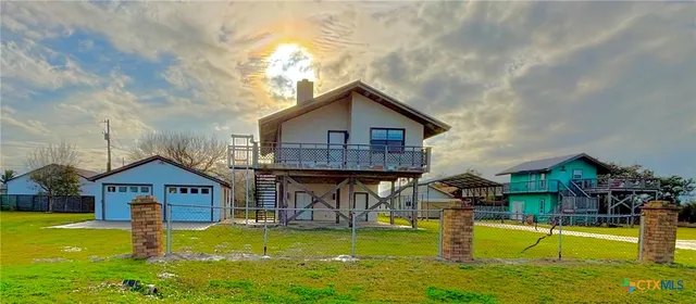 a view of a house with a yard balcony and swimming pool