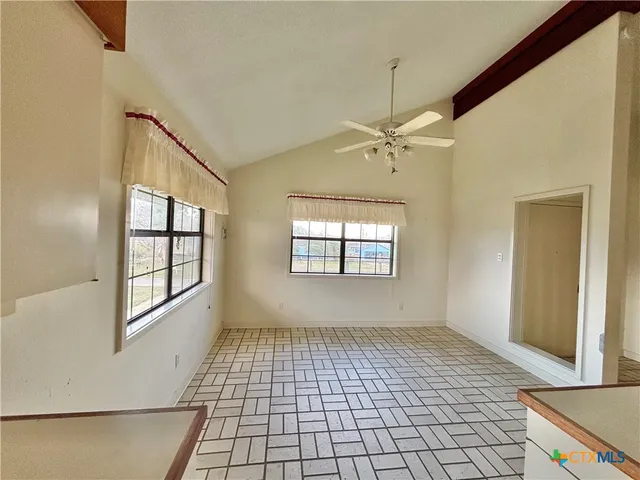 a view of an empty room with a window