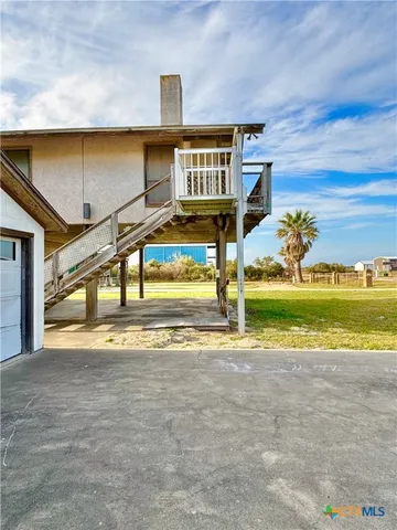 a view of swimming pool with yard and car parked