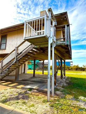 a house view with a swimming pool next to a yard