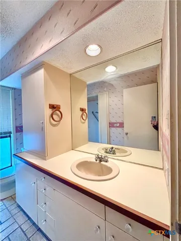a bathroom with a glass shower door