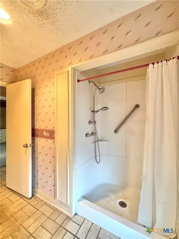a bathroom with a toilet and a shower