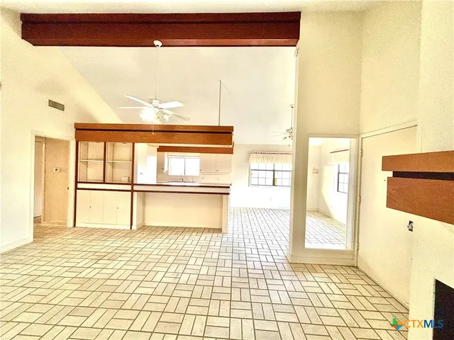a bathroom with a tub and a large window