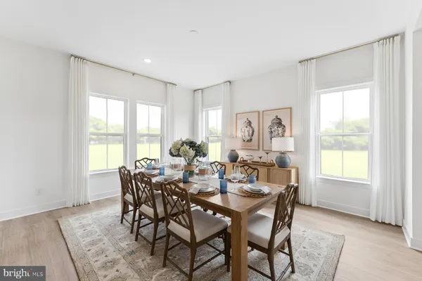 a view of a dining room with furniture and a window