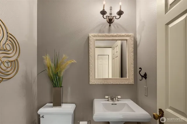 a bathroom with a sink a mirror and a toilet