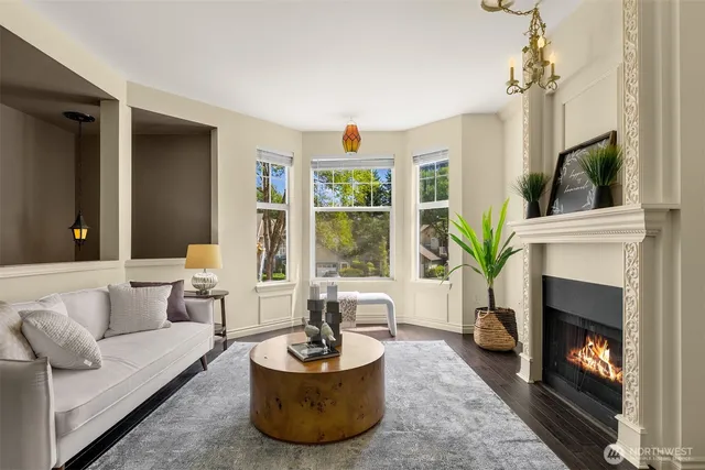 a living room with furniture a window and a fireplace